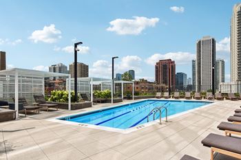 the pool on the rooftop of a building with a city in the background  at Cassidy on Canal, Chicago, Illinois